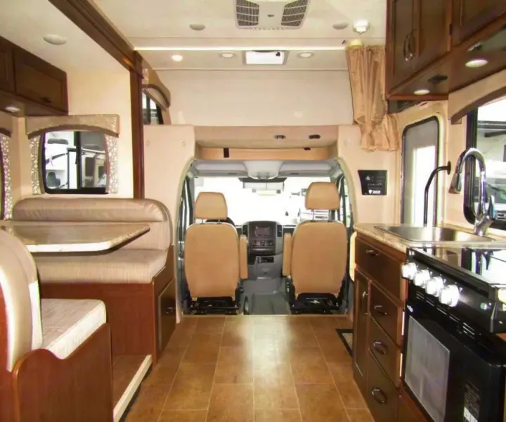 RV rental interior: View from back, showing kitchen (right), dinette (left), and driver's cabin ahead. Bright and ready for travel.. Thor Chateau 2019