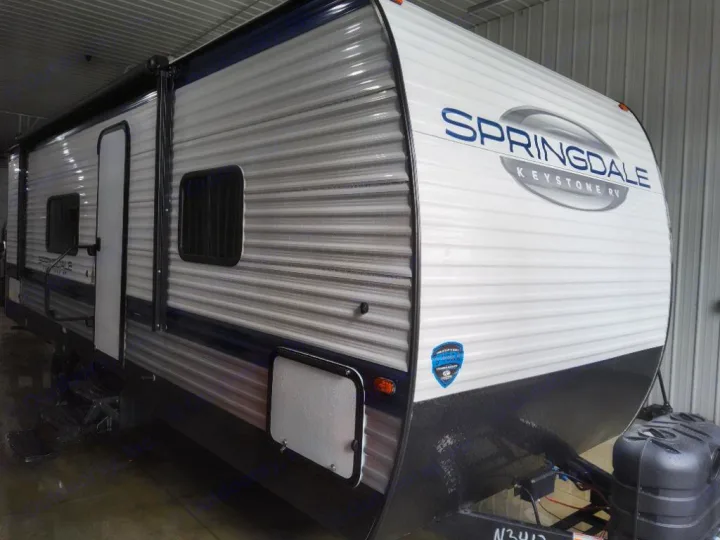 Experience freedom with this sleek white and blue Keystone Springdale travel trailer, an ideal rv rental for your next adventure.. Keystone Springdale Classic 2025