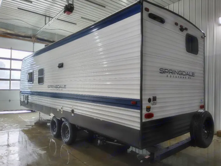 Freshly cleaned Springdale Keystone RV travel trailer ready for rv rental. White with blue trim, dual axles, shown indoors.. Keystone Springdale Classic 2025