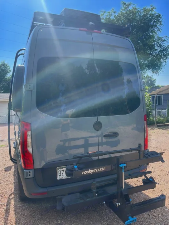 Gray rv rental van, with roof rack, side ladder, & Rockymounts bike rack. Perfect for outdoor adventures!. Storyteller Overland Storyteller Overland Class B 2021