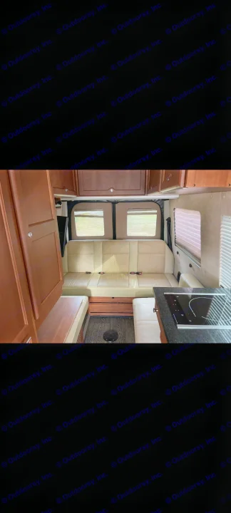Inside this modern RV rental: light bench seating, wood cabinetry, and a compact kitchen with a cooktop.. Roadtrek Roadtrek Class B 2016