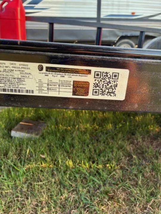 RV rental trailer safety sticker: View tire pressure (50 PSI) and cargo weight limits (2000 lbs) for safe towing.. Carry On Trailers 6X12GWPTLED 2022