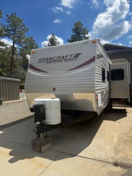 Front view of a clean Starcraft Autumn Ridge RV rental, parked on concrete, ready for your next outdoor adventure.. StarCraft Autumn Ridge 2013