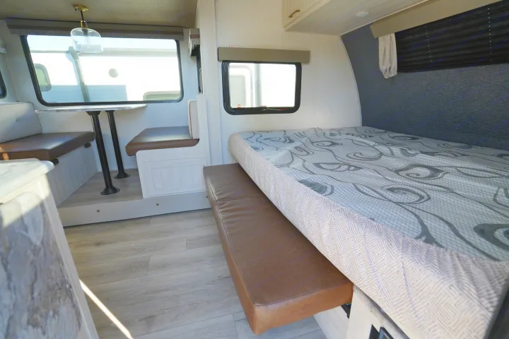 RV rental: Bright, modern interior with a dinette, windows, and a versatile bed area. Perfect for compact travel.. Forest River Surveyor Legend 2024