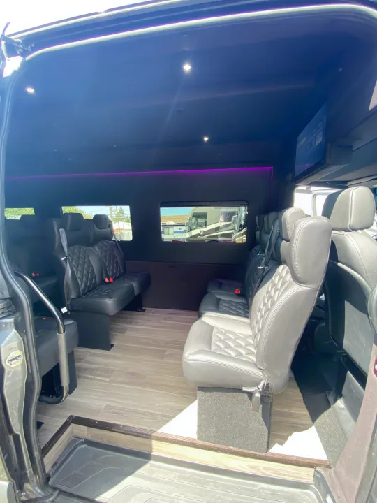 Custom van interior for **RV rental**: black leather seats, wood floor, ambient lighting. Perfect for group travel.. Mercedes-Benz Sprinter 2022