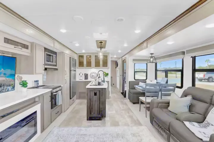Spacious, modern RV rental interior with full kitchen, dining area, and comfortable living room.. Forest River Flagstaff Classic 2024