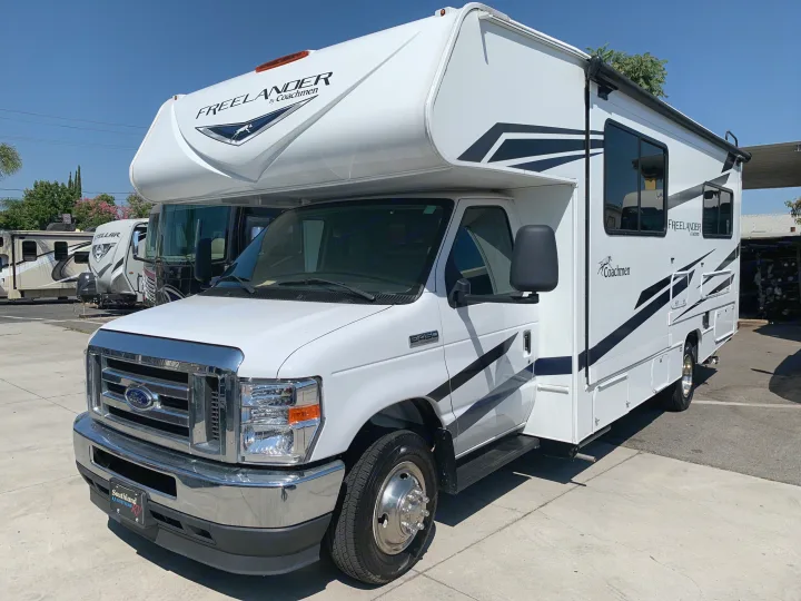 This bright white Class C motorhome, a Freelander Coachmen RV rental, gleams under the sun, ready for adventure.. Coachmen Freelander 2023