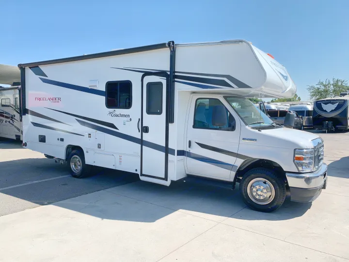 White Freelander Coachmen E-450 Super Duty Class C RV rental motorhome parked on a sunny day.. Coachmen Freelander 2023