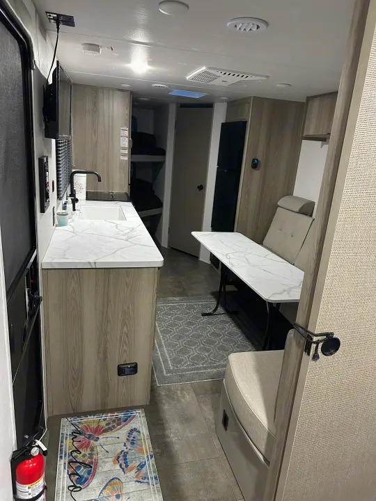 Modern RV rental interior with kitchenette, dinette, and bunk beds. Ideal for family road trips.. Forest River Salem Cruise Lite 2024