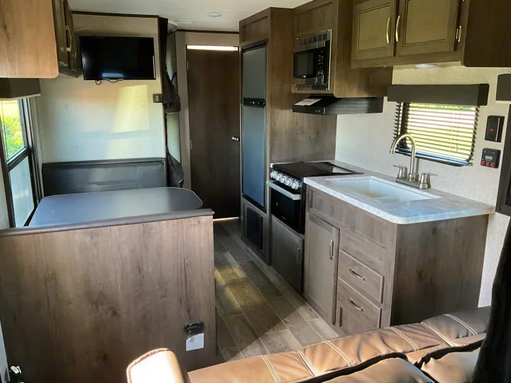 Inside an RV rental: features kitchen, dinette, TV, and lounge seating for your next adventure.. Jayco Jay Flight 2021