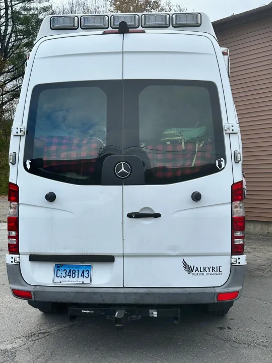 Rear view of a white Mercedes Sprinter RV rental van with roof lights, Connecticut plate, and a "VALKYRIE" sticker.. Mercedes Sprinter 2011