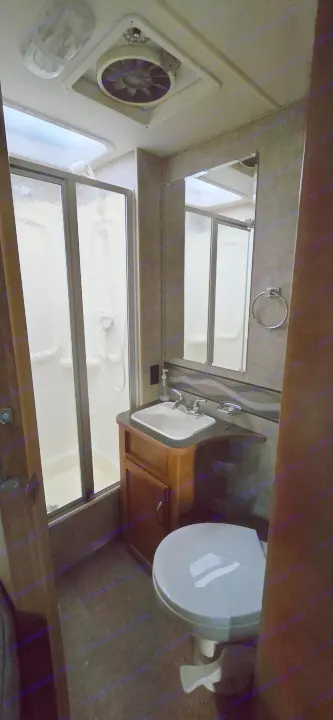 View inside an RV rental bathroom with a compact shower, sink, toilet, and ceiling fan.. Winnebago Minnie Winnie 2019