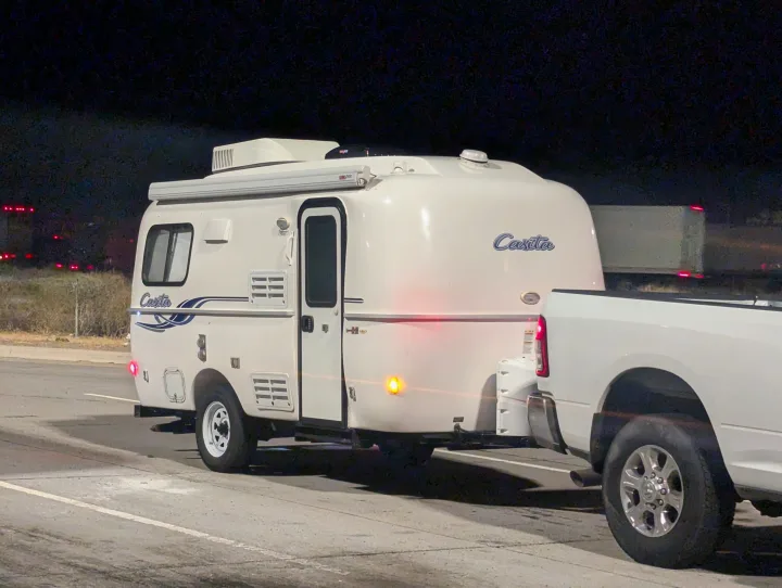 A white Casita travel trailer and pickup truck are parked at night. Consider an RV rental for your adventures.. Casita Casita Trailer 2020