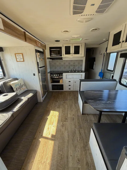 RV rental interior: modern kitchen, cozy living area, and dining booth. Bright, clean, and ready for adventure.. Heartland Trail Runner 2022