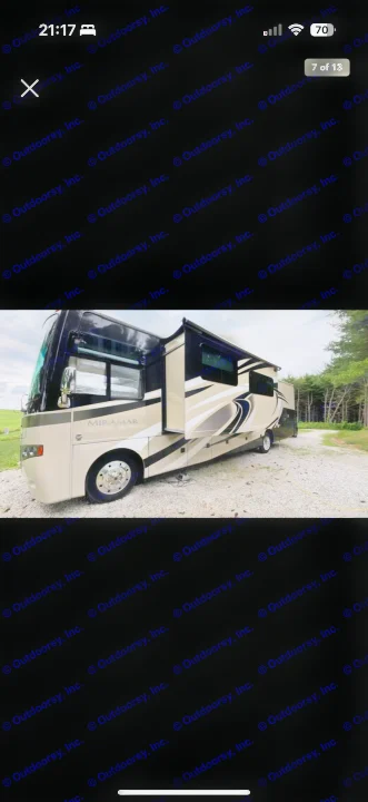 Modern Mirimar RV rental, a tan and black motorhome with extended slide-outs, parked on gravel. Perfect for your next travel adventure!. Thor Miramar 2017