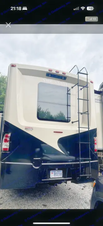 Rear view of a beige and black Miramar RV with a ladder. Consider this well-equipped motorhome for your next rv rental!. Thor Miramar 2017