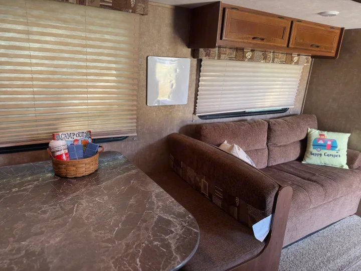 Step inside this RV rental! Features include a cozy dining booth, sofa, overhead cabinets, and window blinds for comfortable travel.. Jayco Jay Flight SLX 2016