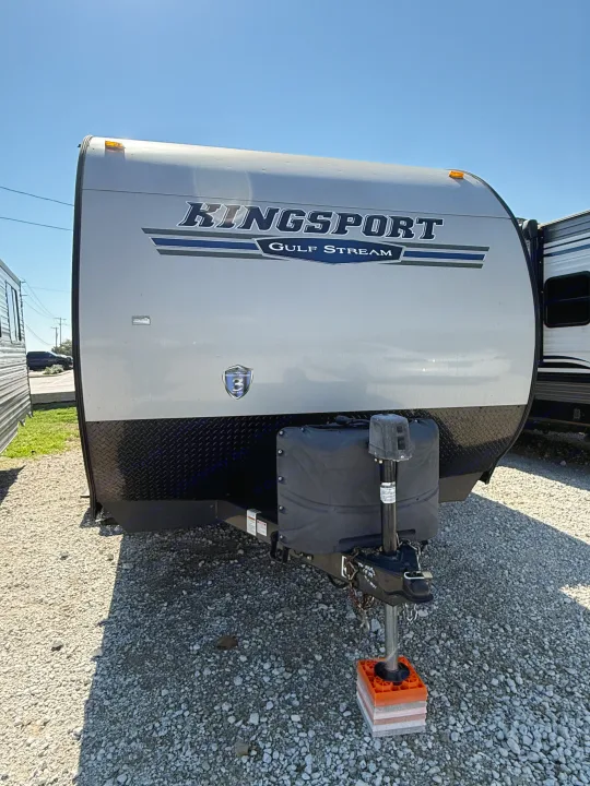 Bright day view of a gray Kingsport Gulf Stream travel trailer, featuring a front hitch, ready for an rv rental.. Gulf Stream Kingsport 2021