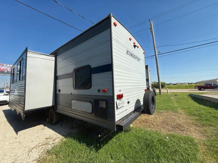 Kingsport travel trailer RV rental, parked with slide-out extended under a clear sky. Ready for your adventure.. Gulf Stream Kingsport 2021