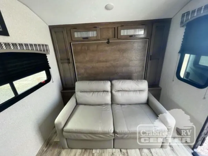 Inside this RV rental: a plush sofa and space-saving murphy bed, perfect for a versatile living area.. Venture Sonic 190VRB 2022