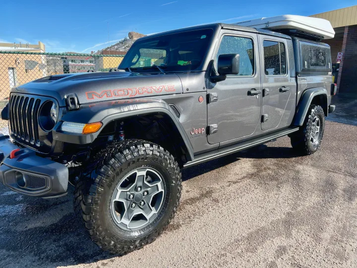 Grey Jeep Gladiator Mojave with a rooftop tent, ideal for your next rv rental adventure.. Custom Jeep Gladiator Mojave 2021