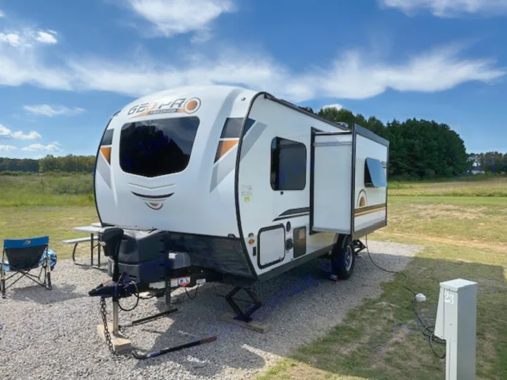 This Geo Pro RV rental is parked at campsite 23 on a sunny day, ready for camping and outdoor adventures.. Forest River Rockwood Geo Pro 2021