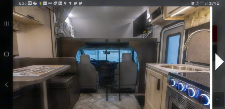 RV rental interior featuring a dinette, kitchen with stove/sink, overhead bunk, and driver's cabin for comfortable travel.. Forest River SLE 2021