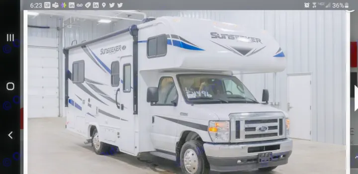 A white Sunseeker Class C RV, built on a Ford chassis, is displayed indoors. Perfect for your next rv rental trip.. Forest River SLE 2021