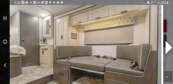 RV rental interior featuring a versatile dinette with seatbelts, convertible sleeping area, and ample overhead storage.. Forest River SLE 2021