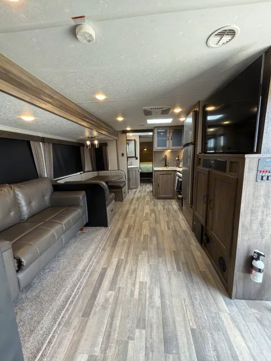 Spacious RV rental interior with modern living, kitchen, and dining areas. Perfect for your next adventure.. Forest River Vibe 2021