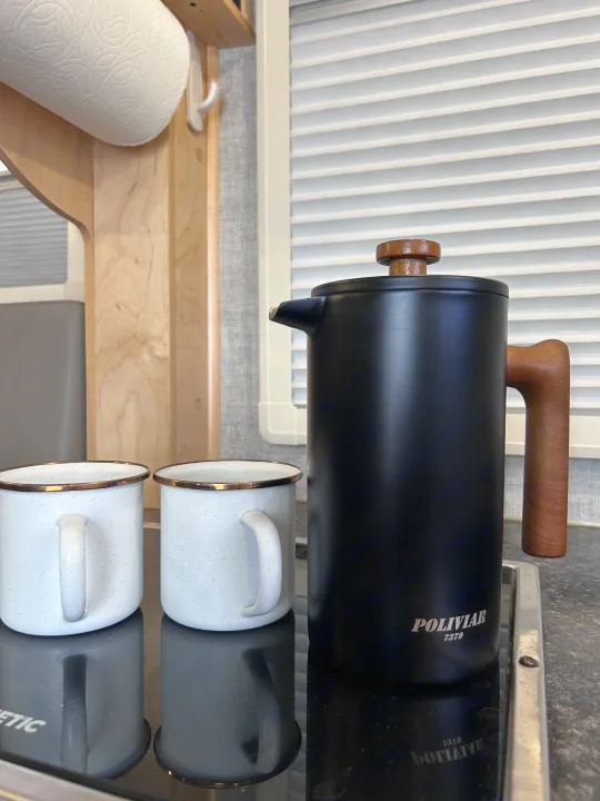 RV rental kitchen essentials: POLIVIAR French press, two enamel mugs, and paper towels, ready for camping.. Xtreme Outdoors Xtreme Outdoors Trailer 2022