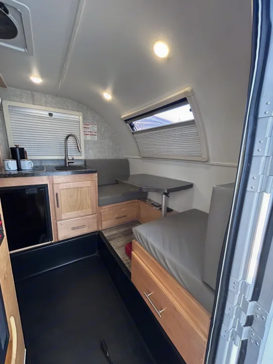 Compact RV rental interior featuring a modern kitchen, cozy dinette, and practical storage solutions.. Xtreme Outdoors Xtreme Outdoors Trailer 2022