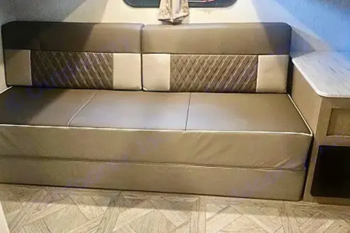 RV rental interior: A beige pull-out sofa converts to a bed, offering practical seating for your trip.. Salem Cruise LIte Platinum 28VBLX 2024