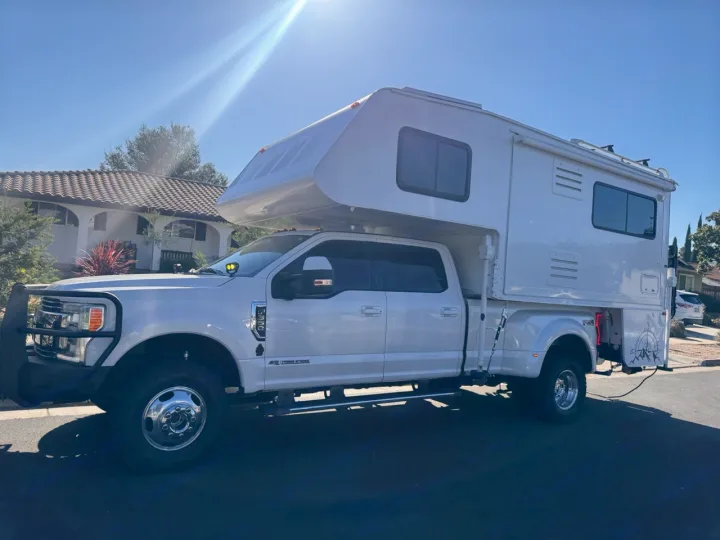 This large white pickup truck with a spacious truck camper makes an ideal RV rental for any adventure on a sunny day.. Ford F350 Diesel Double Cab 2017