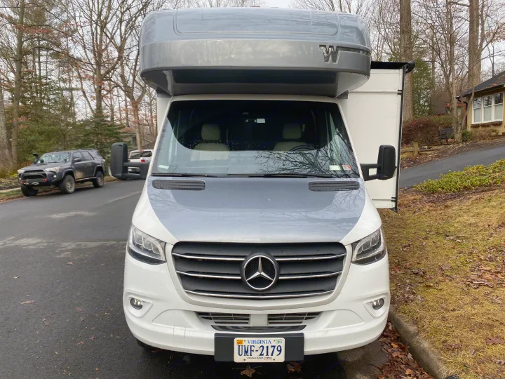 Front view of a white & gray Mercedes-Benz Sprinter Winnebago rv rental with a Virginia license plate.. Winnebago View 2020