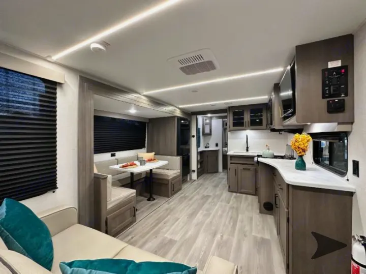 Bright RV rental interior, showcasing a full kitchen, dining nook, and inviting living area for your adventures.. Grand Design Transcend 2026