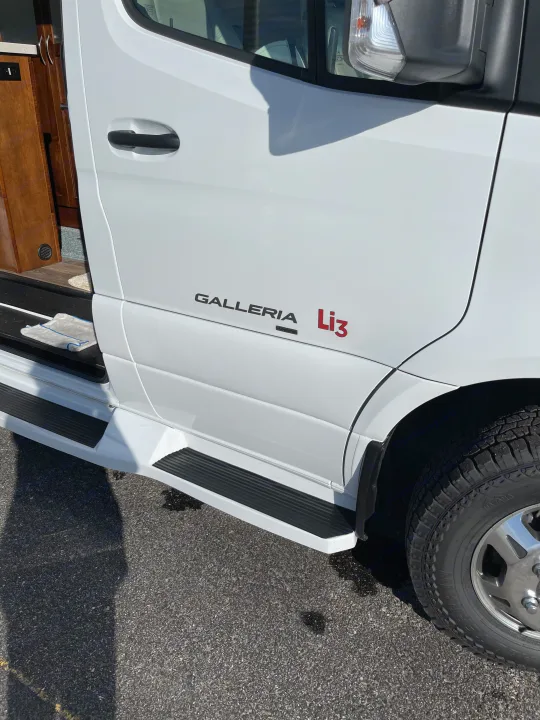White "GALLERIA Li3" RV rental side view with open door and steps. Ideal for a comfortable road trip.. Coachmen Galleria 2021