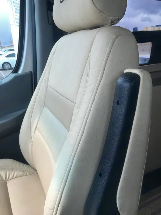 Cream-colored seat with an adjustable armrest in an RV rental, offering comfortable vehicle interior seating.. Coachmen Galleria 2020