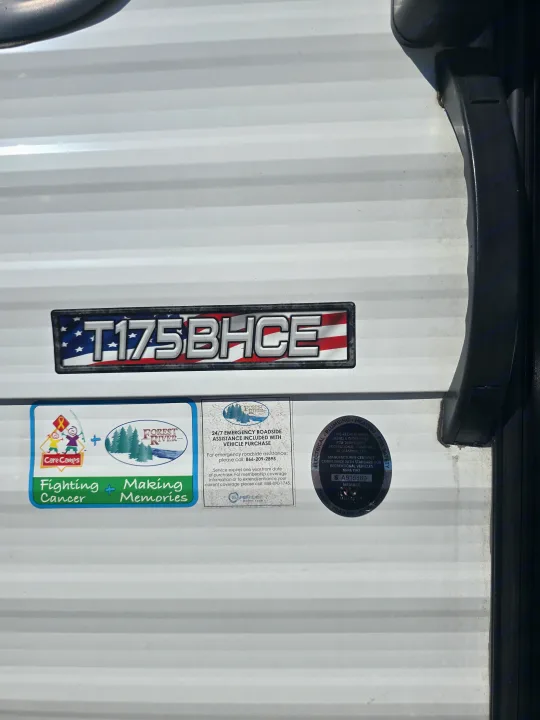 White travel trailer side: T175BHCE model, Forest River, Care Camps stickers, roadside assistance. Great for an rv rental.. Forest River Salem Cruise Lite 2024
