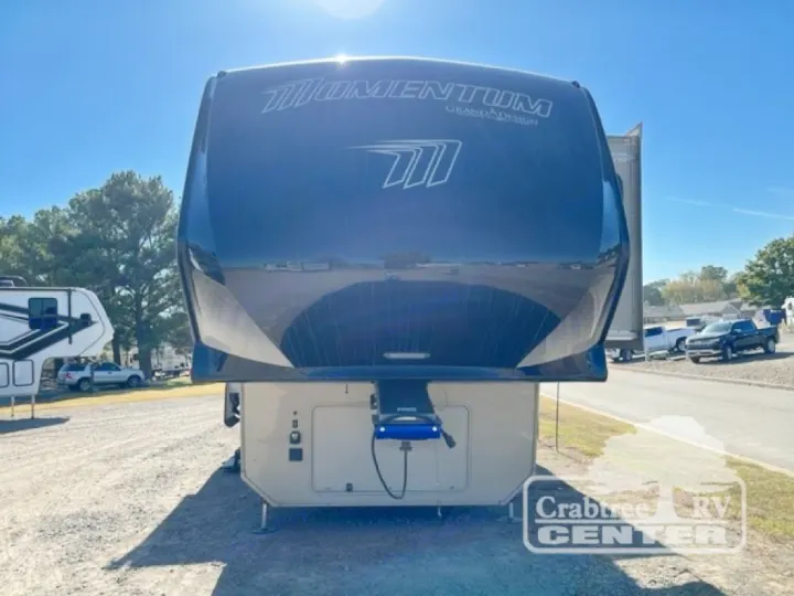 Front view of a dark blue Grand Design Momentum fifth-wheel RV, a perfect option for your next rv rental adventure.. Grand Design Momentum 2015