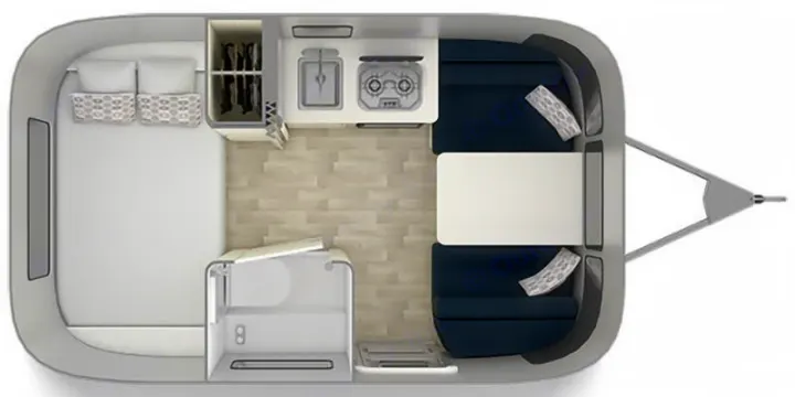 Overhead of a modern RV rental interior, featuring a bed, kitchenette, dinette, and compact bathroom.. Airstream Bambi 2024
