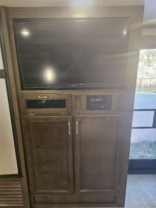 RV rental's entertainment center: Furrion TV, IRV audio system, and storage cabinets, ready for your road trip comfort.. Jayco Jay Flight 2020