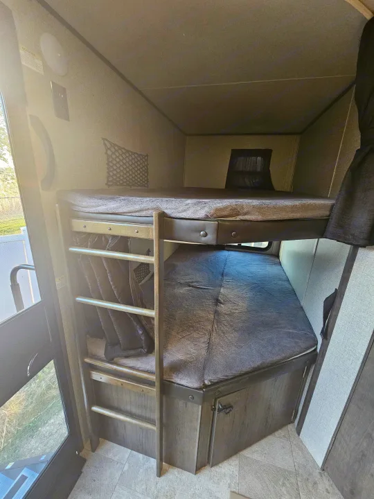 Inside an RV rental: view of comfortable bunk beds, a ladder, and storage. Ideal sleeping quarters for travelers.. Jayco Jay Flight 2020