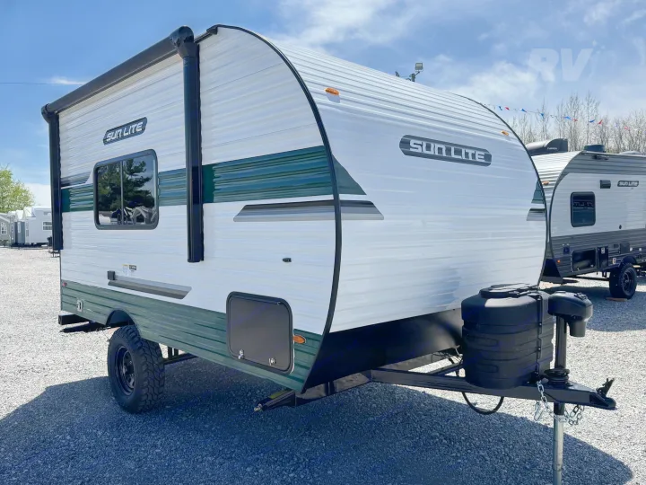 New Sun Lite travel trailer RV rental: white with green trim, off-road tire, and awning.. Sunlite 16BH 2025