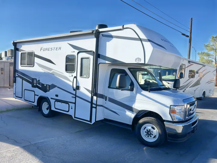White Forester Class C RV rental parked under a clear blue sky, ready for adventure.. Forest River Forester 2026