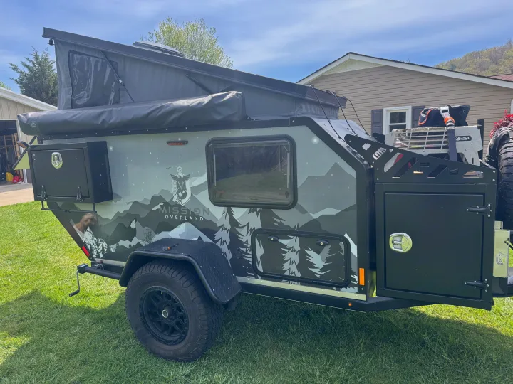 This rugged Mission Overland trailer, featuring mountain graphics, pop-up tent, and off-road tires, is ideal for your next RV rental adventure or off-road camping trip.. Mission Overland Summit 2024