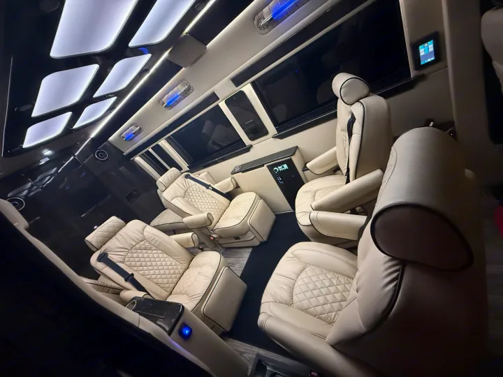 Step into luxury with this RV rental's lavish interior: cream quilted seats, stylish lighting, and modern controls.. Ultimate Toys Ultimate Coach 2023