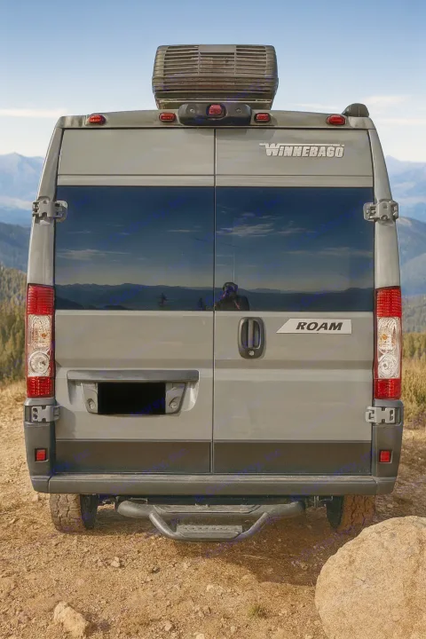 Grey Winnebago Roam RV rental's rear view, parked on a mountain trail. Ideal for adventure, travel, and van life.. Winnebago Roam 2024