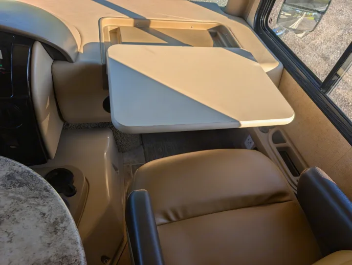 RV rental: Front passenger seat with extended table, dashboard, and large window. Perfect for comfortable travel & work.. Thor Miramar 2015