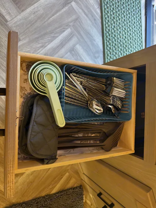 RV rental kitchen drawer organized with measuring cups, silverware, pot holders, and utensils for easy access.. Cruiser RV Shadow Cruiser 2021